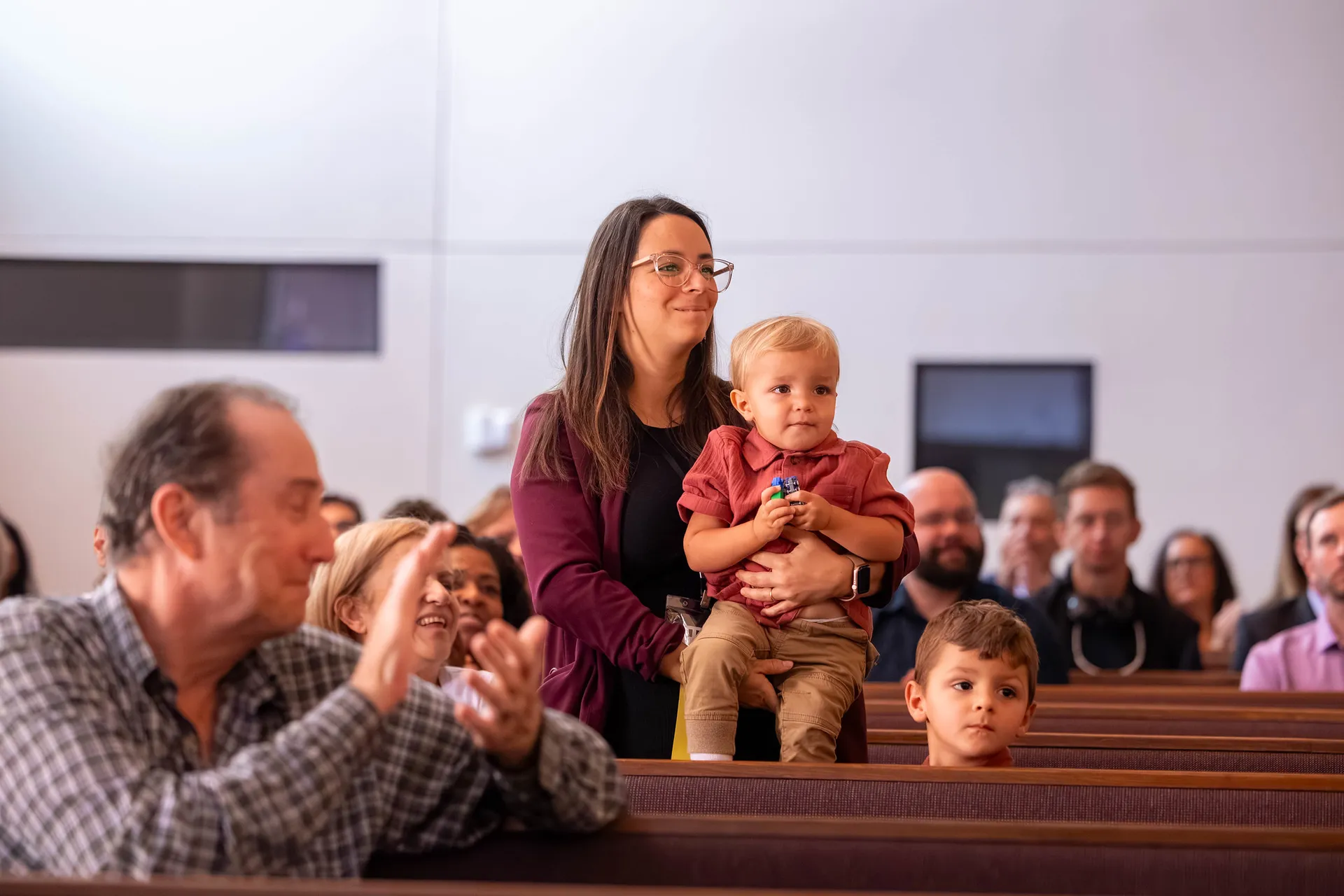 Woman standing in church holding child