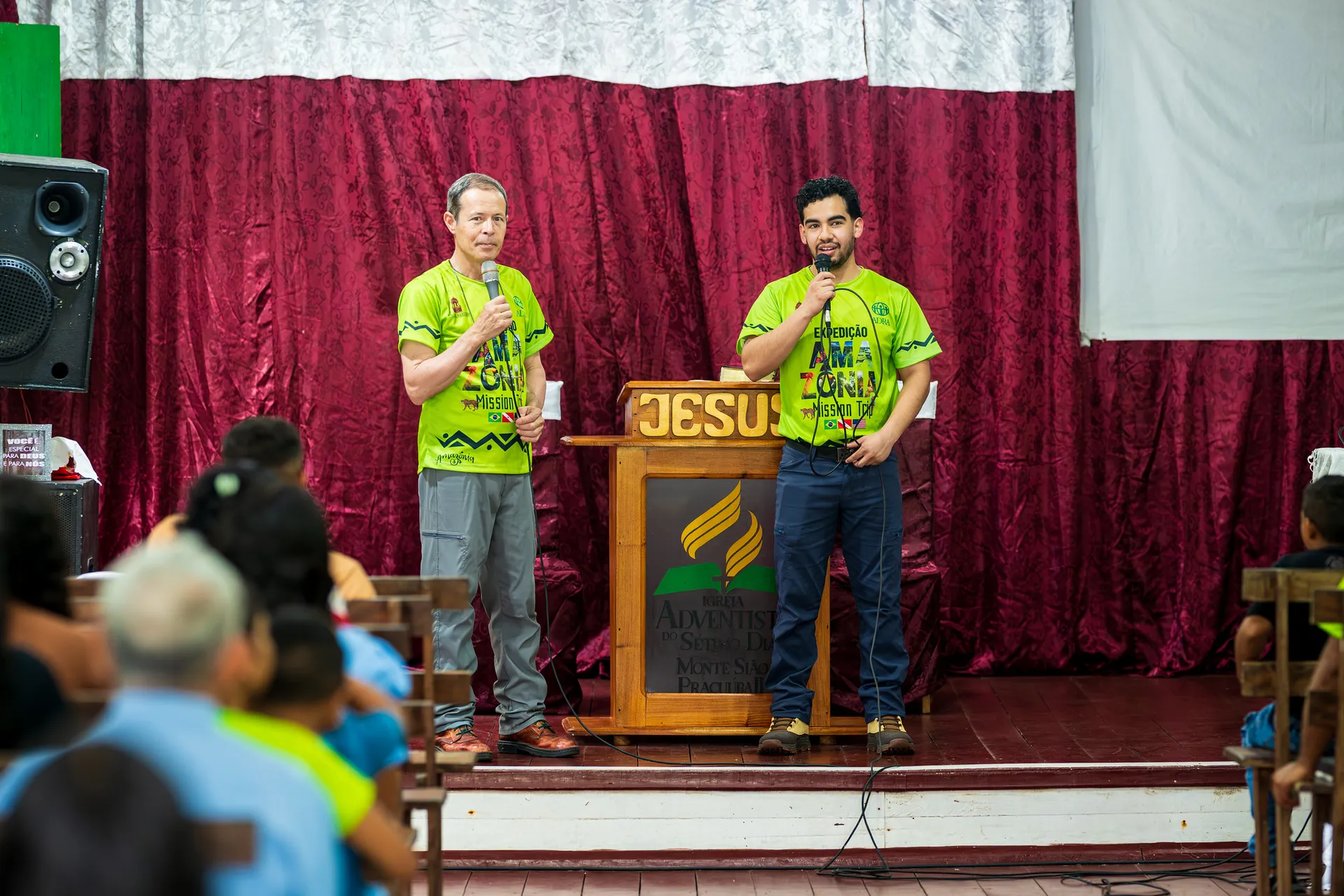 Two speakers in front of a podium