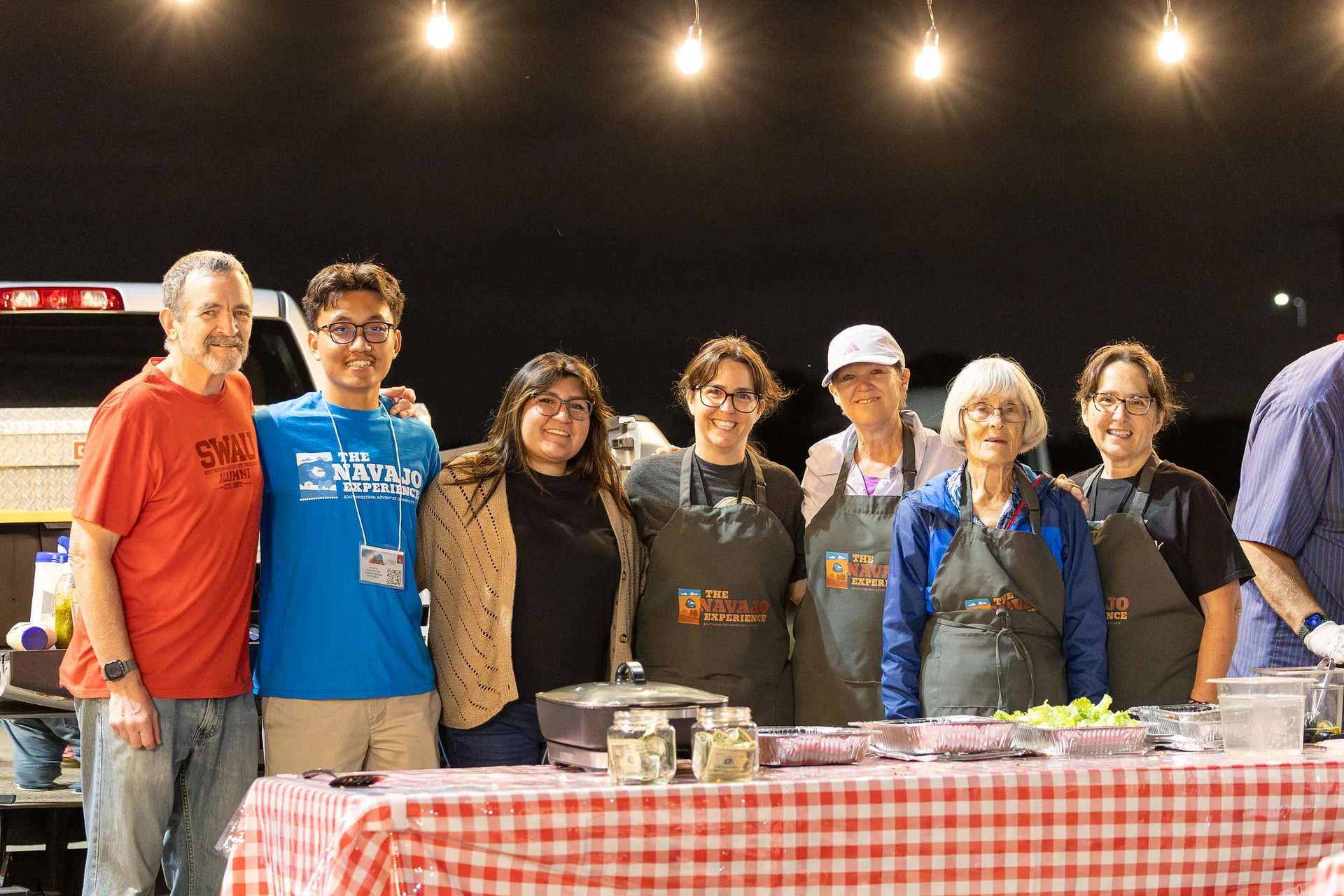 Group photo in front of food table
