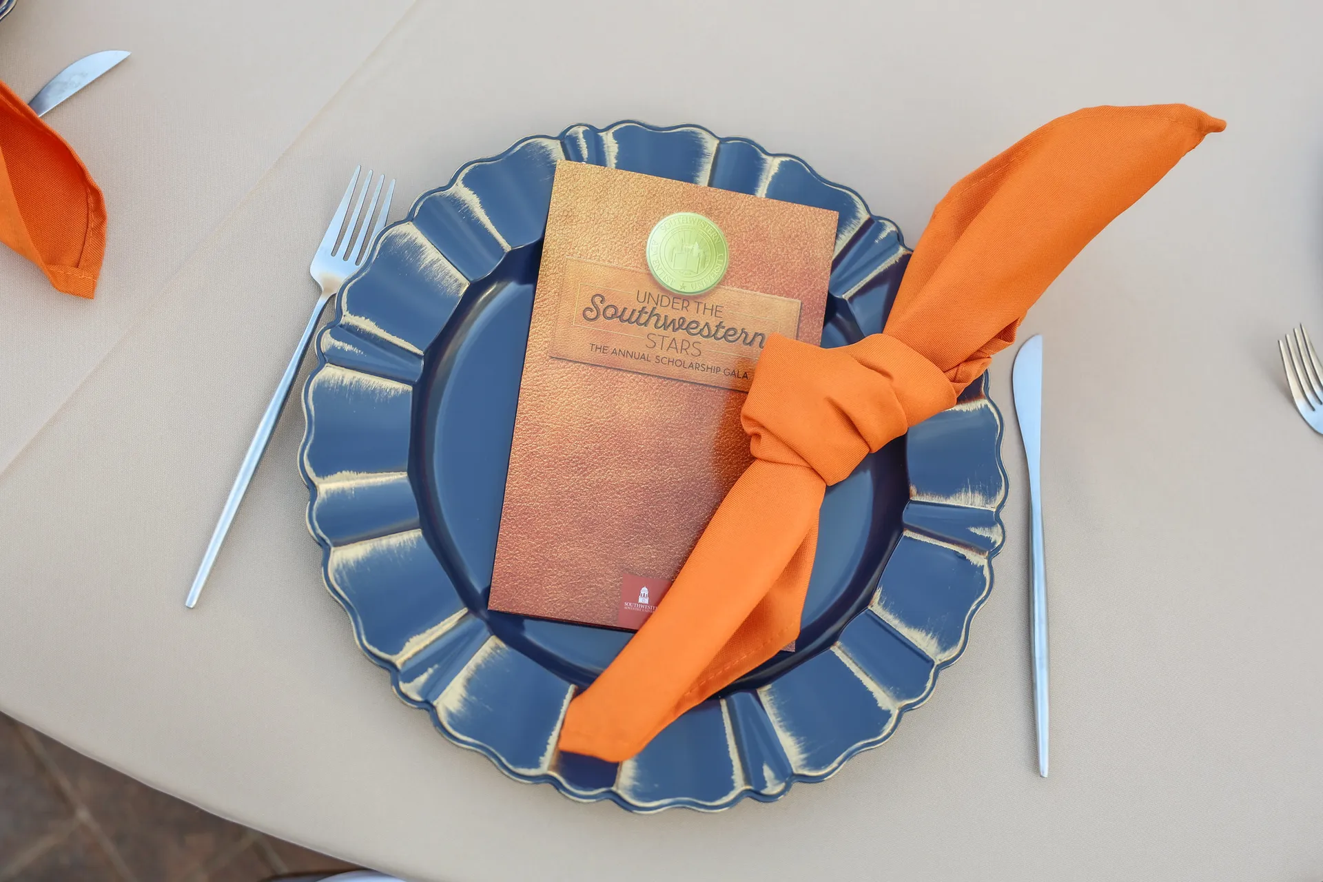 Dinner plate with a napkin and a program on it