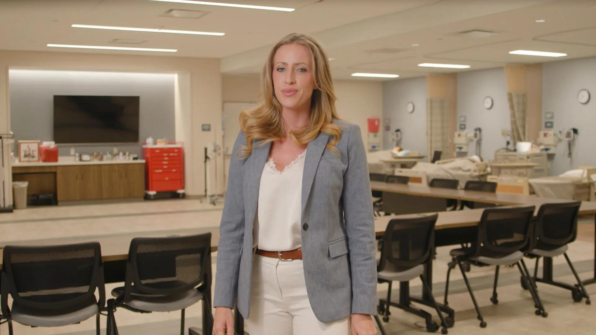 A teacher standing in front a nursing simulation classroom