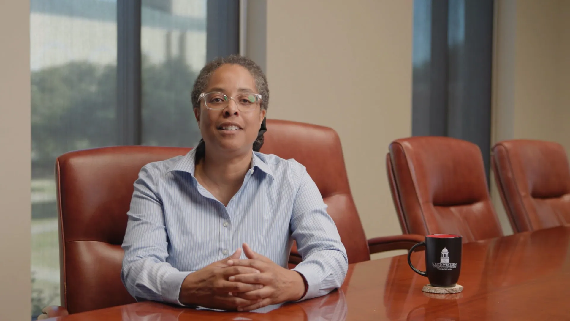 A teacher sitting at a conference table