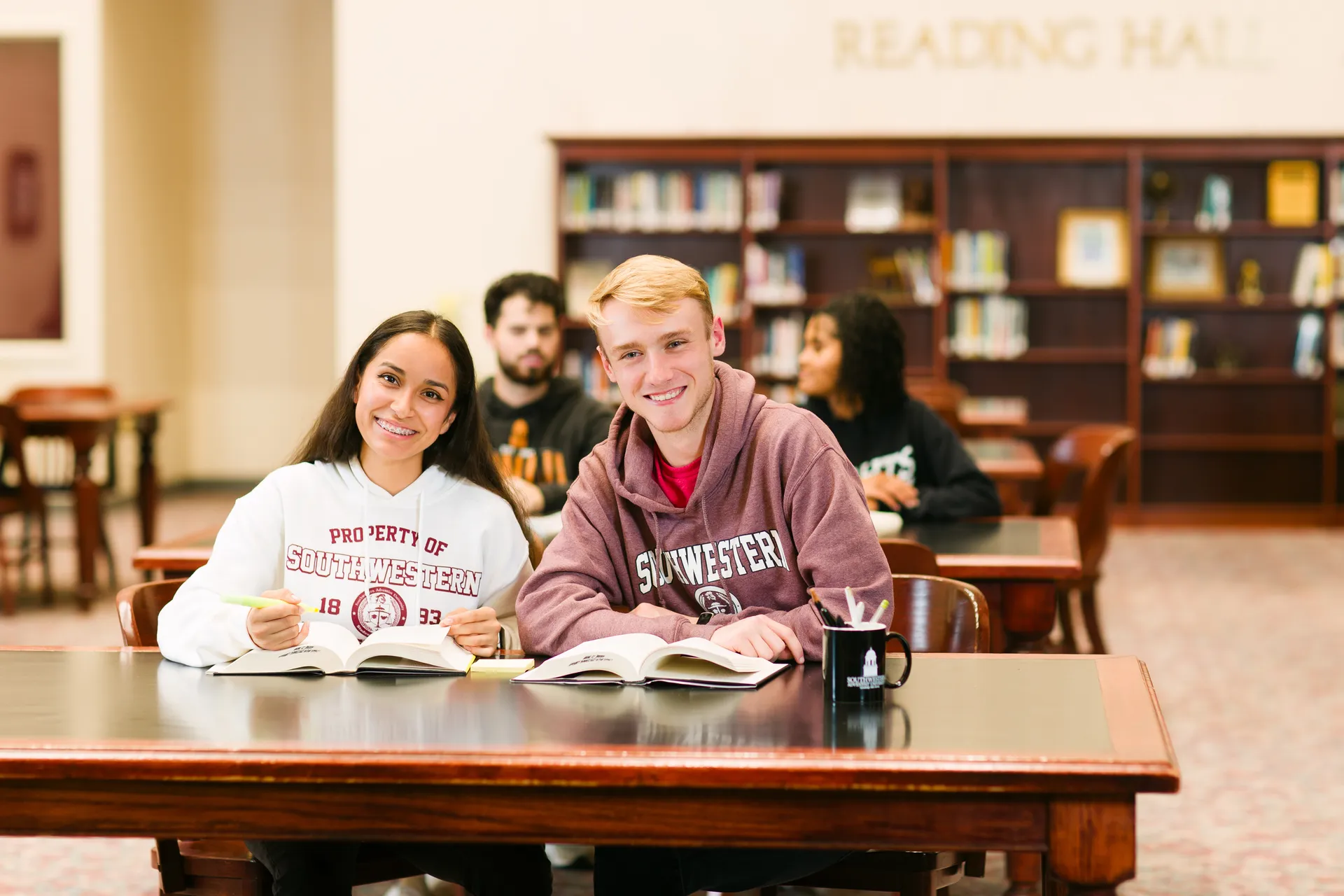 People at library table studying