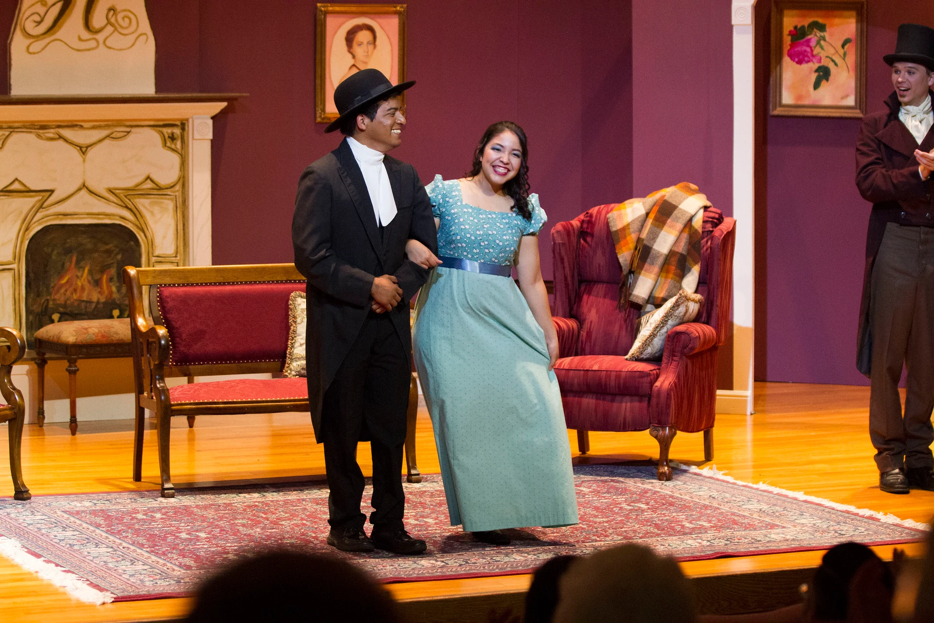 Two students stand, arms intertwined, and bow as they finish up their play